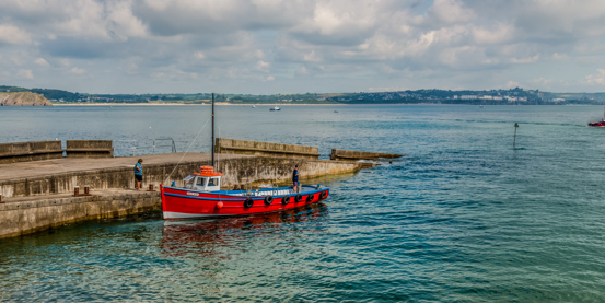 Wide shot of boat moored in West Wales